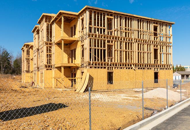 a close-up of temporary chain link fences enclosing a construction site, signaling progress in the project's development in Chuluota, FL